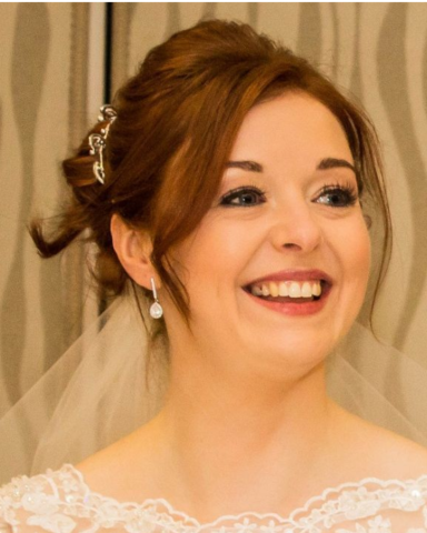 Bride smiling at the camera at the Grosvenor Pulford Hotel after her radiant bridal makeup. 