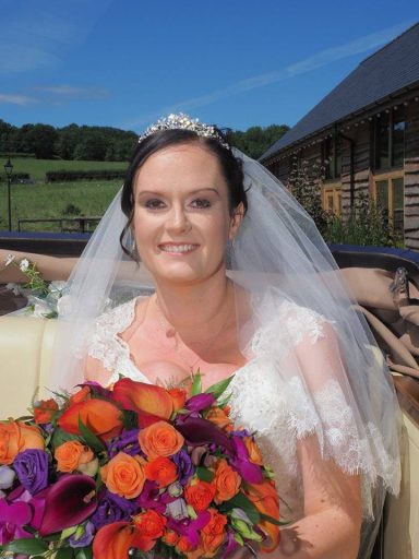 Cheadle based bride beams on her wedding day, in wedding car.