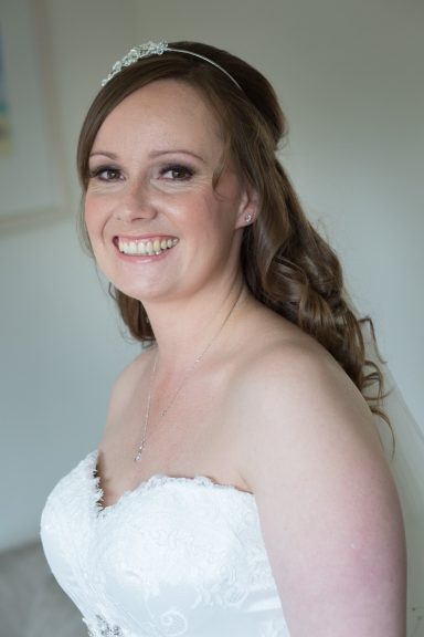 Close up of bride with peachy makeup on her wedding day in Chester home