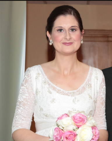Bride smiling at the camera after her professional bridal makeup. 