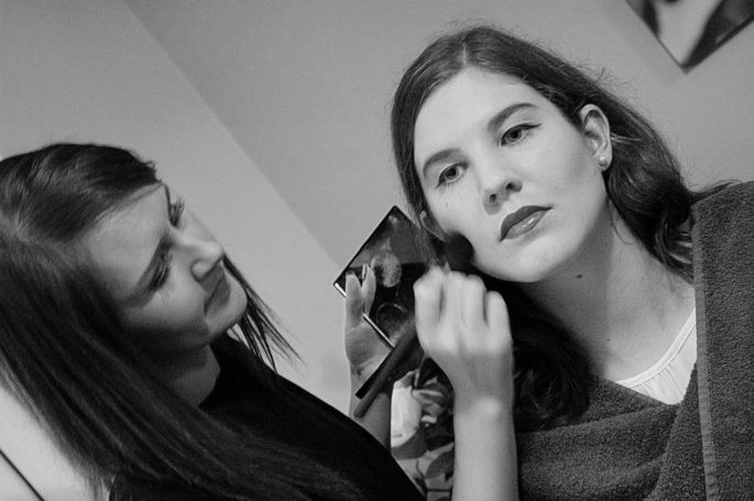 Kirsty applying makeup to bridal party member.