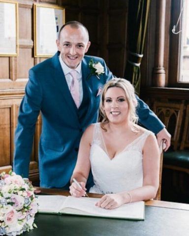 Glowing bride signing the Wedding Register at Chester Town Hall