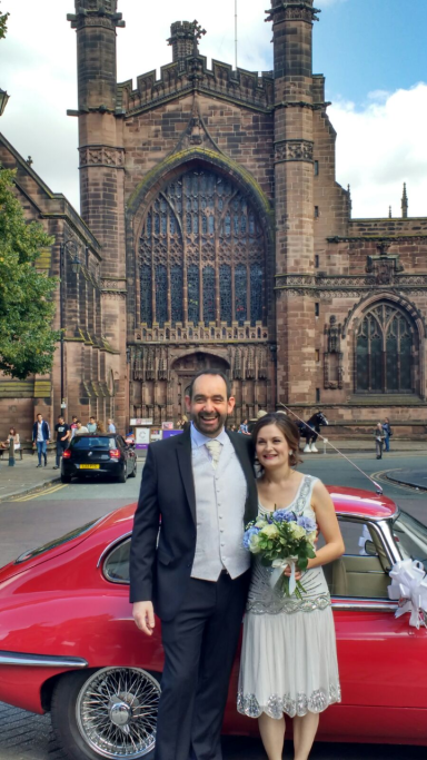 Couple outside Chester Cathedral, after their wedding at Chester Town Hall; bride is 20s vintage themed, including her makeup