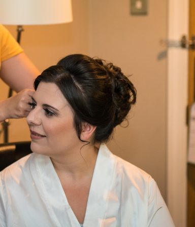 Bride smiling at the camera in Cheshire, after her professional bridal makeup.