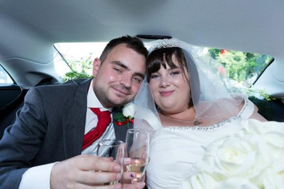 Close up of couple in car after their wedding, highlighting the glowing skin of the bride